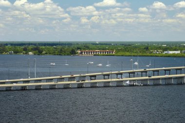 Barron Collier Bridge and Gilchrist Bridge in Florida with moving traffic. Transportation infrastructure in Charlotte County connecting Punta Gorda and Port Charlotte over Peace River.