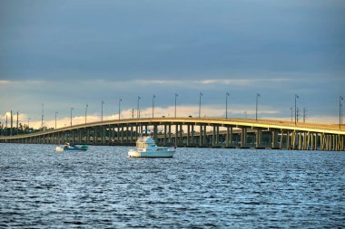 Barron Collier Bridge and Gilchrist Bridge in Florida with moving traffic. Transportation infrastructure in Charlotte County connecting Punta Gorda and Port Charlotte over Peace River.