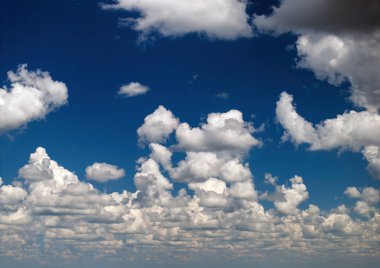 Bright landscape of blue sky with flying white clouds. Colorful summer skyscape. clipart