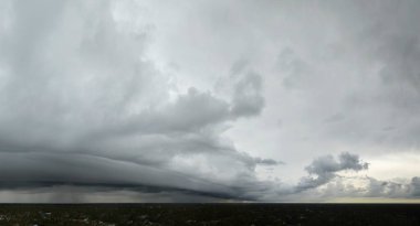 Stormy cumulonimbus clouds forming before thunderstorm on dark sky. Moving and changing cloudscape weather. clipart