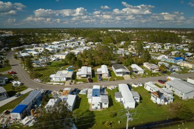 Severely damaged houses after hurricane Ian in Florida mobile home residential area. Consequences of natural disaster. clipart