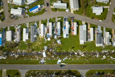 Severely damaged houses after hurricane Ian in Florida mobile home residential area. Consequences of natural disaster. clipart