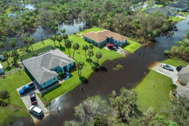 Aftermath of natural disaster. Surrounded by hurricane Ian rainfall flood waters homes in Florida residential area. clipart