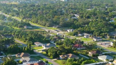 Küçük bir kasabada araba süren kırsal sokak trafiğinin hava görüntüsü. Florida 'da sakin yerleşim bölgesinde özel evleri olan Amerikan banliyö manzarası