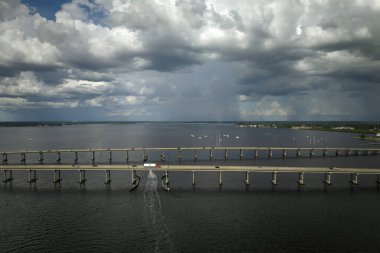 Barron Collier Bridge and Gilchrist Bridge in Florida with moving traffic. Transportation infrastructure in Charlotte County connecting Punta Gorda and Port Charlotte over Peace River.