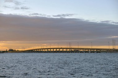 Barron Collier Bridge and Gilchrist Bridge in Florida with moving traffic. Transportation infrastructure in Charlotte County connecting Punta Gorda and Port Charlotte over Peace River.