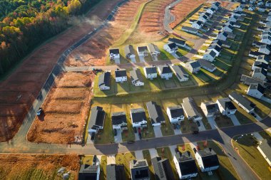 Real estate development with tightly located family houses under construction in South Carolina suburban area. Concept of growing american suburbs.