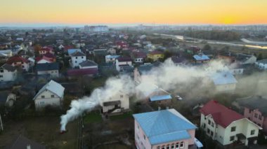 Aerial view of agricultural waste bonfires from dry grass and straw stubble burning with thick smoke polluting air causing global warming and carcinogen fumes.