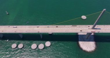 Florida 'daki Tampa Körfezi üzerinde Sunshine Skyway Köprüsü' nde araba sürüyor. Amerika 'da ulaşım altyapısı.