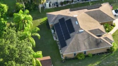 Evin çatısındaki güneş panelleri. Fotovoltaik, kenar mahallelerde temiz elektrik enerjisi üretmek için satılıyor. Özerk konutlara yatırım kavramı.