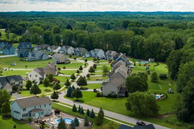 Düşük yoğunluklu iki katlı özel evler Rochester, New York 'un dışındaki kırsal yerleşim yerlerinde. Büyük arsa büyüklüğünde lüks banliyö evleri ve yaz mevsiminde yeşil çimenli çimenler.