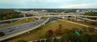 Aerial view of american freeway intersection with fast moving cars and trucks. USA transportation infrastructure concept. clipart