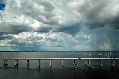 Barron Collier Bridge and Gilchrist Bridge in Florida with moving traffic. Transportation infrastructure in Charlotte County connecting Punta Gorda and Port Charlotte over Peace River.