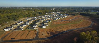 Real estate development with tightly located family houses under construction in South Carolina suburban area. Concept of growing american suburbs.