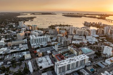 Aerial view of Sarasota city downtown at sunset with bay marina yachts and high-rise office buildings. Real estate development in Florida. USA travel destination. clipart