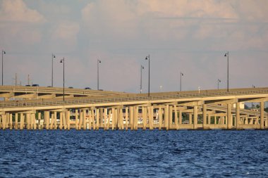Barron Collier Bridge and Gilchrist Bridge in Florida with moving traffic. Transportation infrastructure in Charlotte County connecting Punta Gorda and Port Charlotte over Peace River.