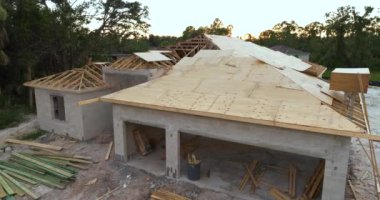 Yeni ev inşaatında çatı inşaatı. Florida 'nın banliyö bölgesinde yerleşim yerinin tamamlanmamış kontrplak çatısı. Konut geliştirme kavramı.