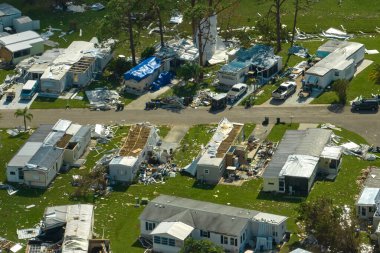 Severely damaged houses after hurricane Ian in Florida mobile home residential area. Consequences of natural disaster. clipart