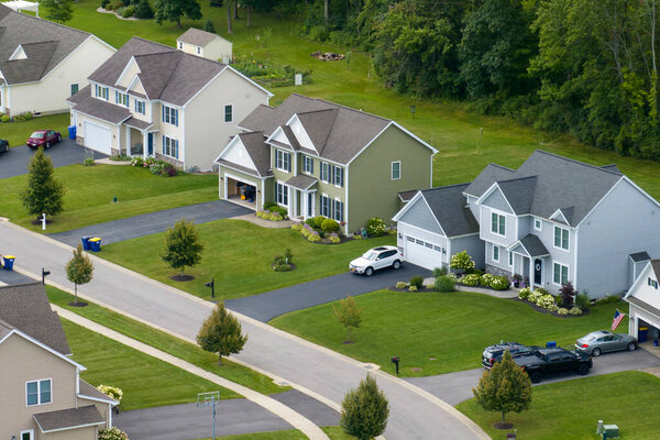 Top view of expensive two story private houses in Rochester NY suburbia. New family homes in upscale community. Real estate development in american suburbs.