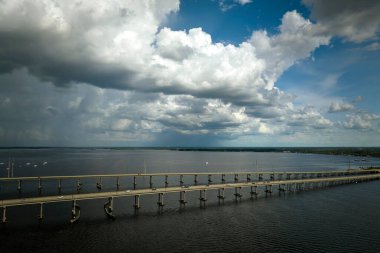 Barron Collier Bridge and Gilchrist Bridge in Florida with moving traffic. Transportation infrastructure in Charlotte County connecting Punta Gorda and Port Charlotte over Peace River.