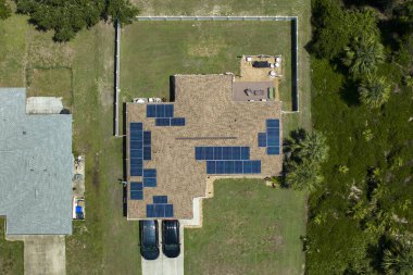 Temiz ekolojik elektrik enerjisi üretmek için mavi güneş fotovoltaik panelleri olan Amerikan ana çatısının havadan görünüşü. Sıfır emisyon kavramı ile yenilenebilir elektrik.