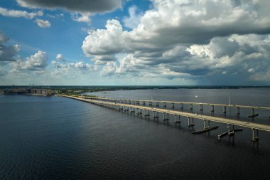 Barron Collier Bridge and Gilchrist Bridge in Florida with moving traffic. Transportation infrastructure in Charlotte County connecting Punta Gorda and Port Charlotte over Peace River.