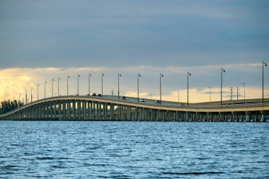 Barron Collier Bridge and Gilchrist Bridge in Florida with moving traffic. Transportation infrastructure in Charlotte County connecting Punta Gorda and Port Charlotte over Peace River.