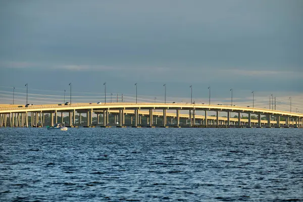Barron Collier Bridge and Gilchrist Bridge in Florida with moving traffic. Transportation infrastructure in Charlotte County connecting Punta Gorda and Port Charlotte over Peace River.