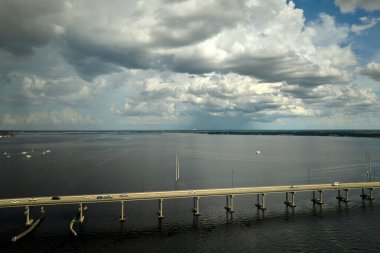 Barron Collier Bridge and Gilchrist Bridge in Florida with moving traffic. Transportation infrastructure in Charlotte County connecting Punta Gorda and Port Charlotte over Peace River.