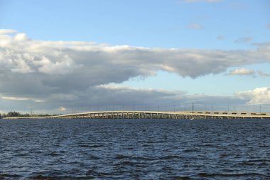 Barron Collier Bridge and Gilchrist Bridge in Florida with moving traffic. Transportation infrastructure in Charlotte County connecting Punta Gorda and Port Charlotte over Peace River.