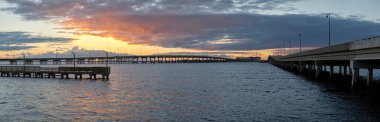 Barron Collier Bridge and Gilchrist Bridge in Florida with moving traffic. Transportation infrastructure in Charlotte County connecting Punta Gorda and Port Charlotte over Peace River.