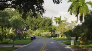 Car point of view driving. Timelapse speed effect. Transportation and traffic concept. Vehicle driving on suburban street between homes in Venice, Florida residential area