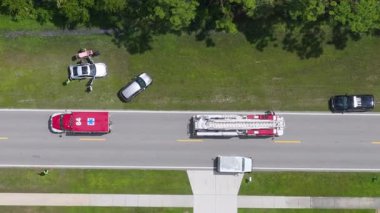 First responders treat a car accident victim, using a medical stretcher at the scene of a traffic incident on a public road in America