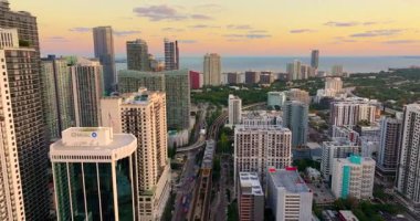 Florida, ABD 'deki Miami şehir merkezinden geçen tren ve demiryolu hattı. Günbatımında modern yüksek binaların olduğu bir şehirde temel ulaşım altyapısı