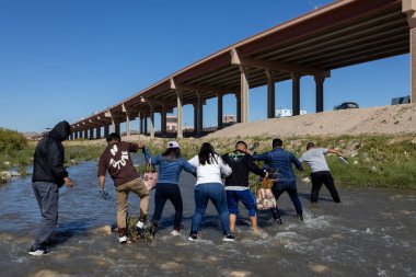 Juarez, Mexico 10-21-2022: Venezuelan migrants cross the Rio Grande, the natural border between Mexico and the United States, families seek to request asylum.