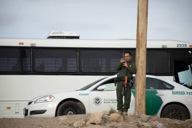 Juarez, Mexico, 11-15-2022: Border Patrol agents monitor the migrant camp set up in Mexican territory on the Juarez El Paso Texas border.