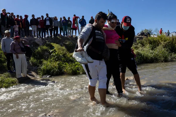 Juarez, Mexico 10-21-2022: Venezuelan migrants cross the Rio Grande, the natural border between Mexico and the United States, families seek to request asylum.