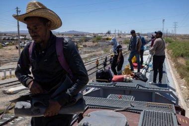 Hundreds of migrants arrive by train to Ciudad Juarez, Mexico, ready to cross the border into the United States in search of a better life. (05/13/23) clipart