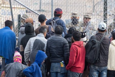 Yüzlerce göçmen, insani sığınma talebinde bulunmak umuduyla ABD-Meksika sınırındaki Teksas Ulusal Muhafız Teşkilatı tarafından fark edilmeden geçmeyi bekliyor..
