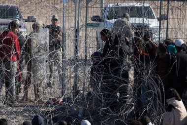Yüzlerce göçmen, insani sığınma talebinde bulunmak umuduyla ABD-Meksika sınırındaki Teksas Ulusal Muhafız Teşkilatı tarafından fark edilmeden geçmeyi bekliyor..