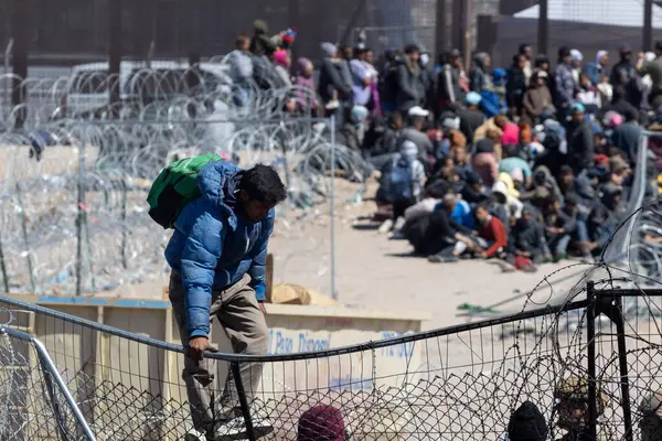 Yüzlerce göçmen, insani sığınma talebinde bulunmak umuduyla ABD-Meksika sınırındaki Teksas Ulusal Muhafız Teşkilatı tarafından fark edilmeden geçmeyi bekliyor..