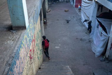 Ciudad Juarez 'de duvar yazısıyla dolu bir sokakta dolaşan bir genç, göç zorluklarının ortasındaki dayanıklılığı simgeliyor..