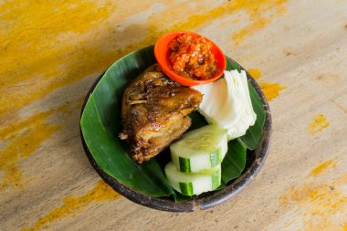 Grilled chicken with spicy spices cooked in the traditional way with firewood.