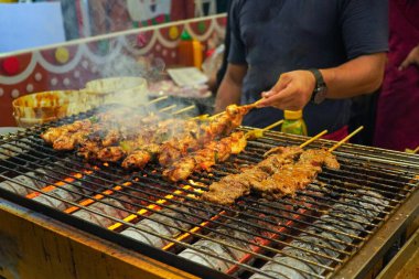 Izgara et ve tavuklu satay özel bir gaz ızgarası fırınında..