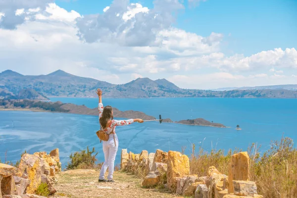 happy latin woman on vacation on isla del sol taking selfie with