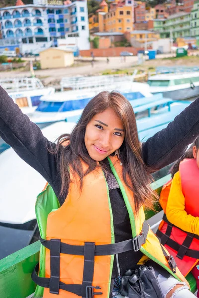 happy latin woman smiling on vacation boat on bolivia lake titic