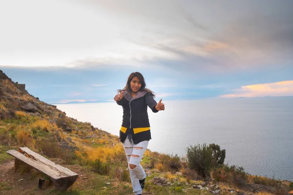 latin woman happy and smiling at sunset on the shores of lake ti