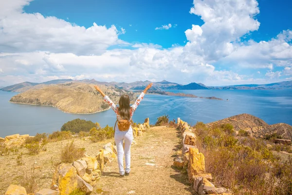 latin woman traveling on isla del sol in lake titicaca in summer