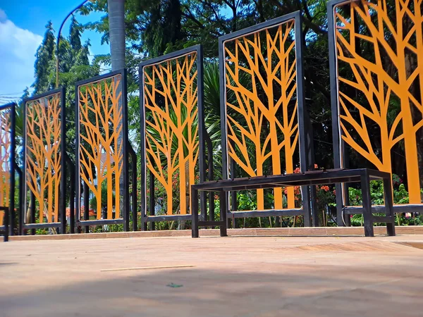 Metal Privacy Screen Fence, Metal Tree Wall Art, gold and black in frame, this was shot at square park Madiun, East Java, Indonesia.
