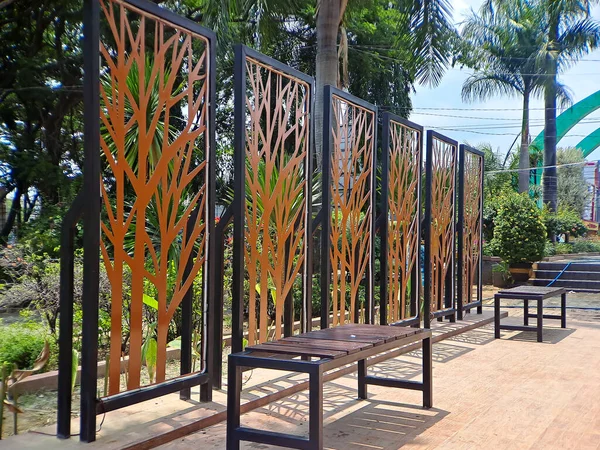 Metal Privacy Screen Fence, Metal Tree Wall Art, gold and black in frame, this was shot at square park Madiun, East Java, Indonesia.